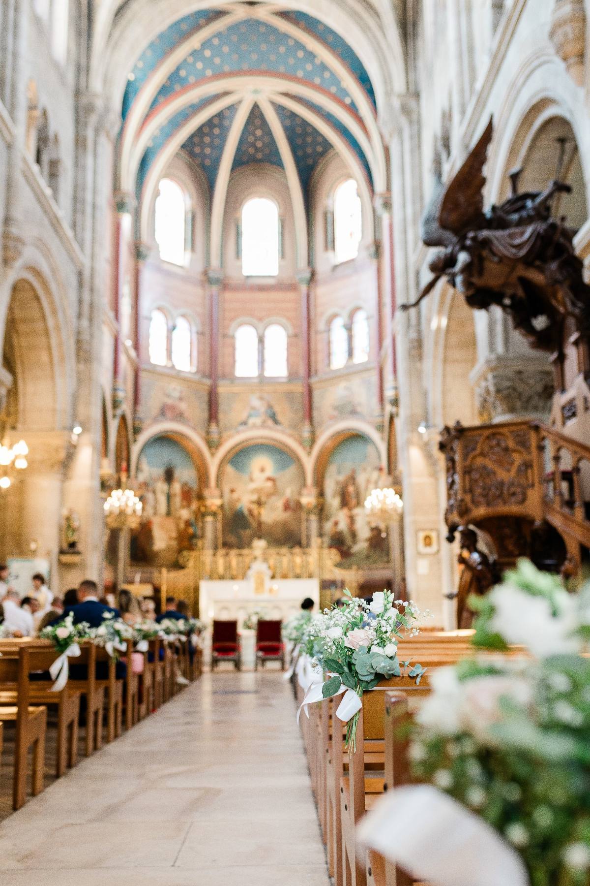 Intérieur de cathédrale gothique décorée de fleurs blanches pour une cérémonie